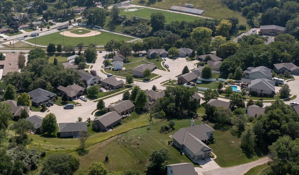 An aerial view of a neighborhood filled with large single-family homes on cul-de-sacs
